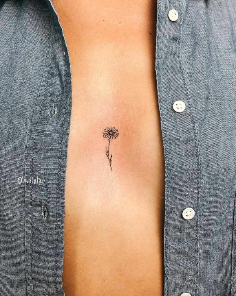Tiny flower sternum tattoo