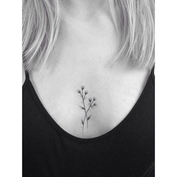 Tiny flower sternum tattoo