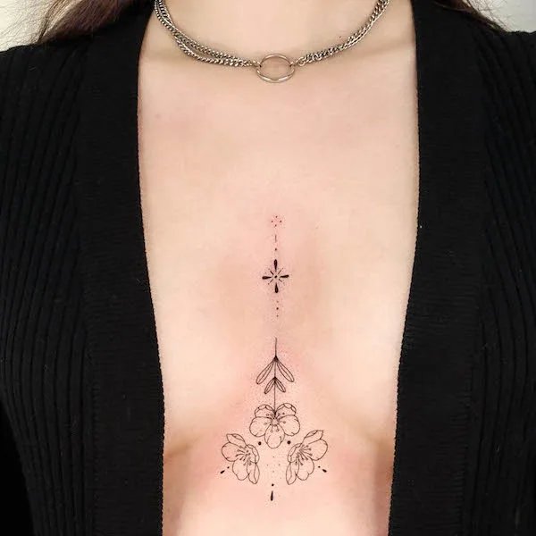 Floral ornament in between breast tattoo