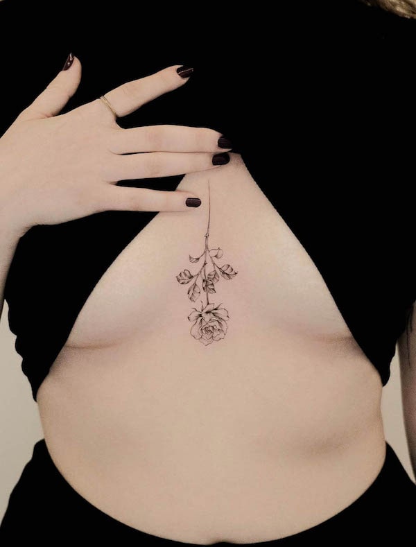 Reversed rose tattoo between breast