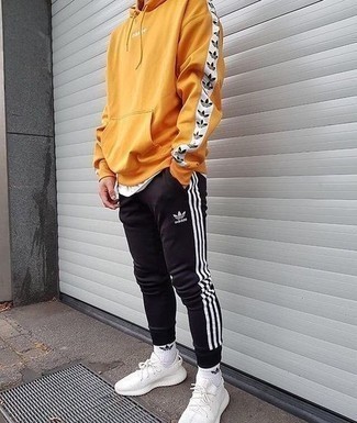 Black pants + Pastel yellow sweater + White sneakers