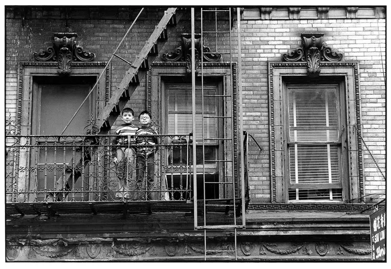 Chinese brothers on a tenement fire escape on Mulberry Street. NYC, 1977.

